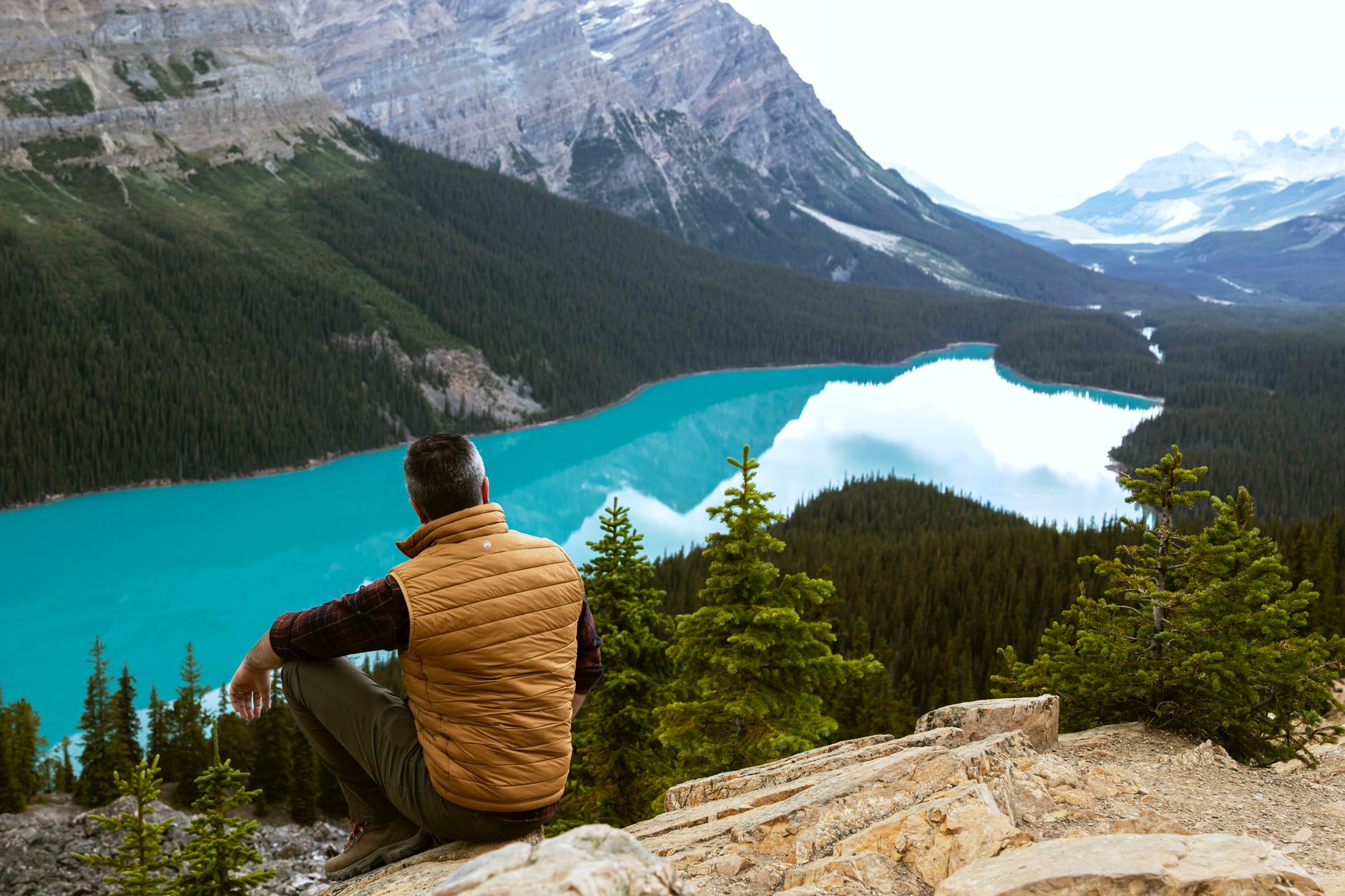 man sitting near lake